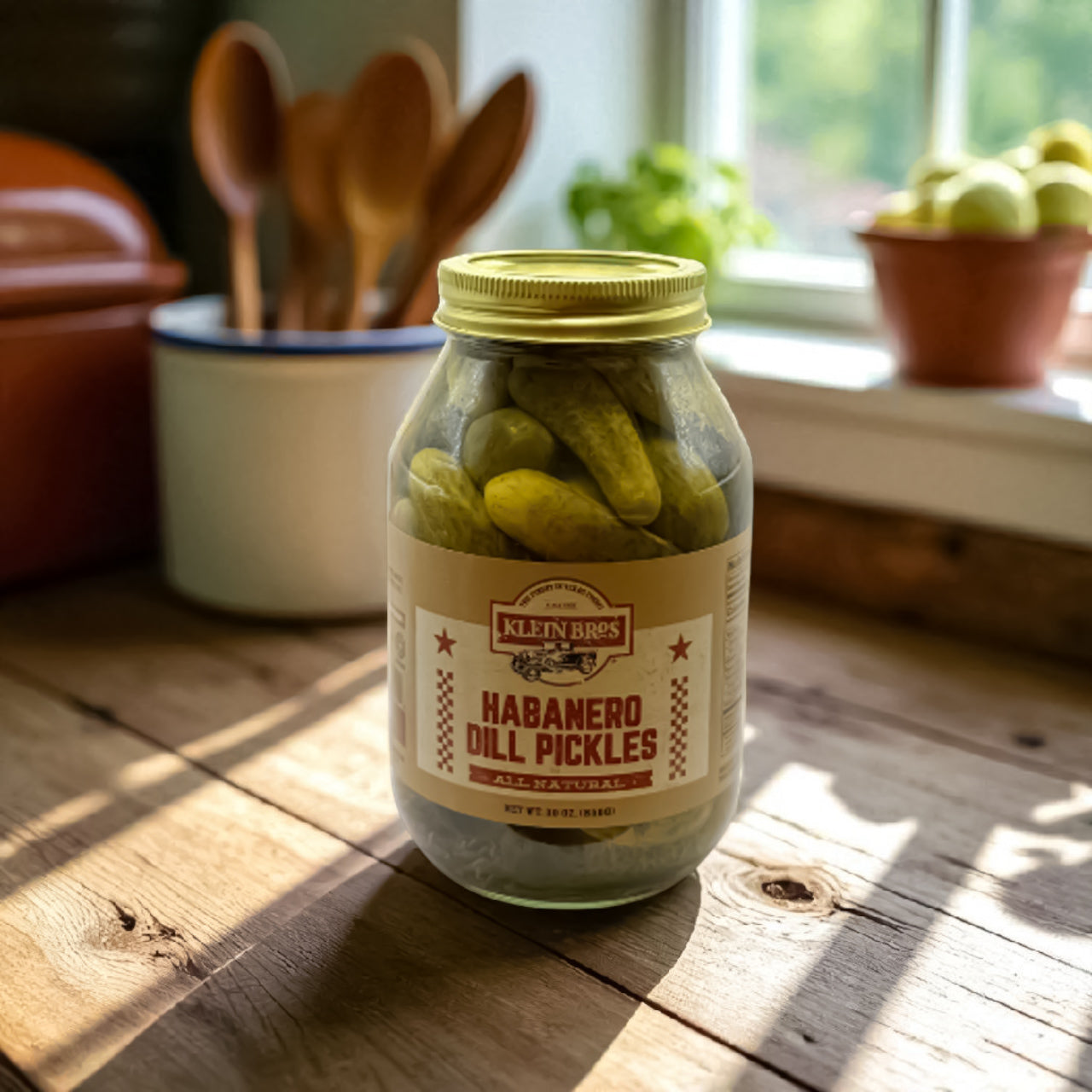 Jar of Habanero Dill Pickles on a wooden table with kitchen utensils in the background