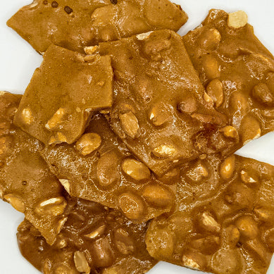 Close-up of peanut brittle on a white background