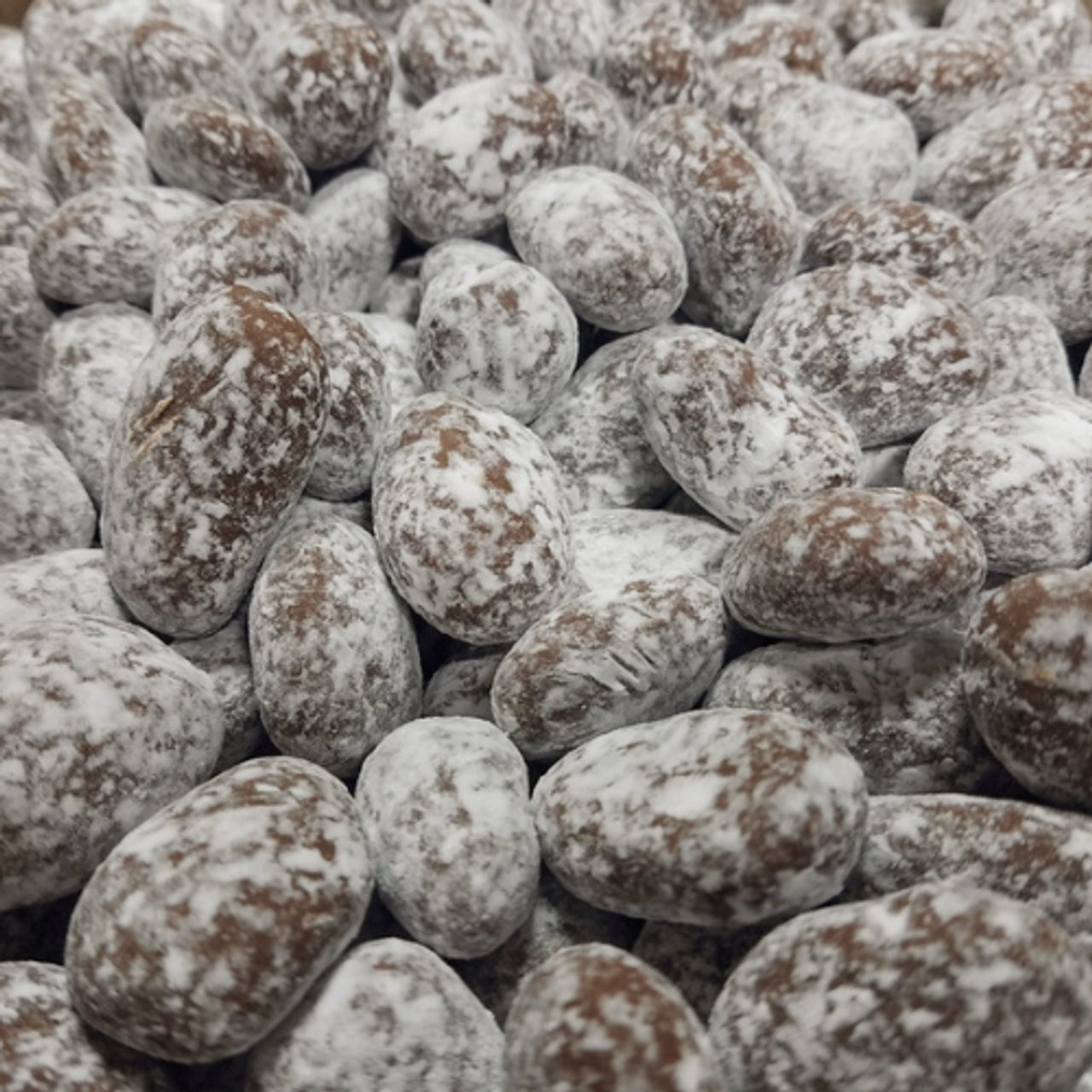 Close-up of roasted and salted almonds with a snowy texture.