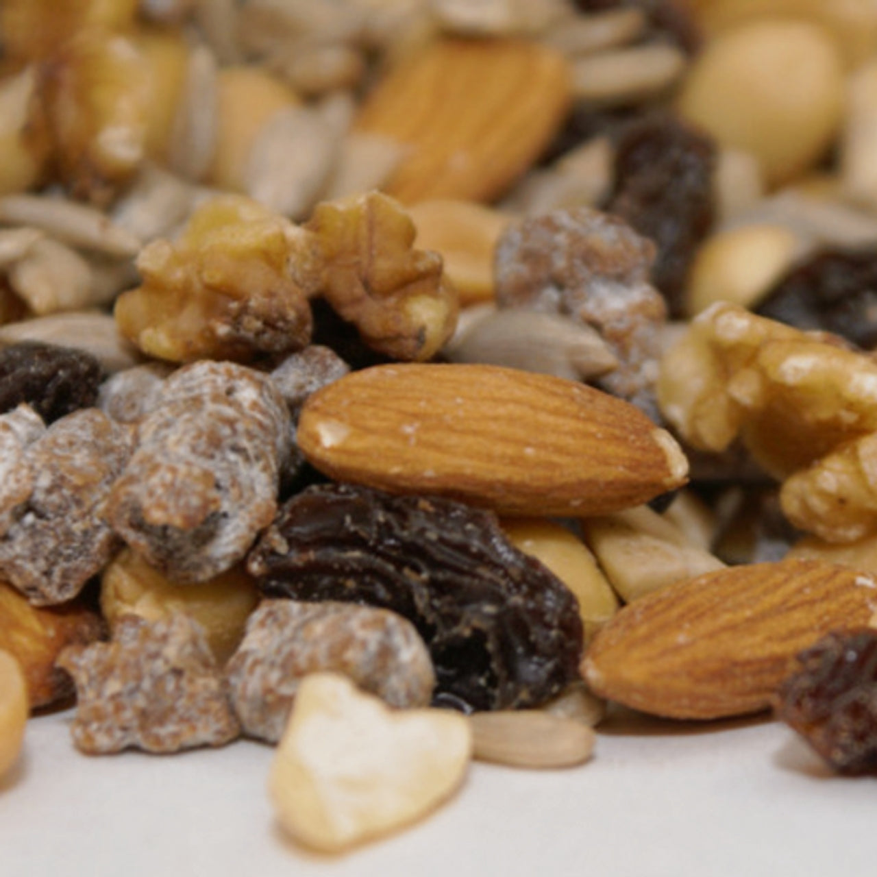 Close-up of a mix of nuts and seeds on a white background