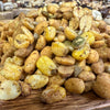Assorted roasted nuts and seeds on a wooden surface