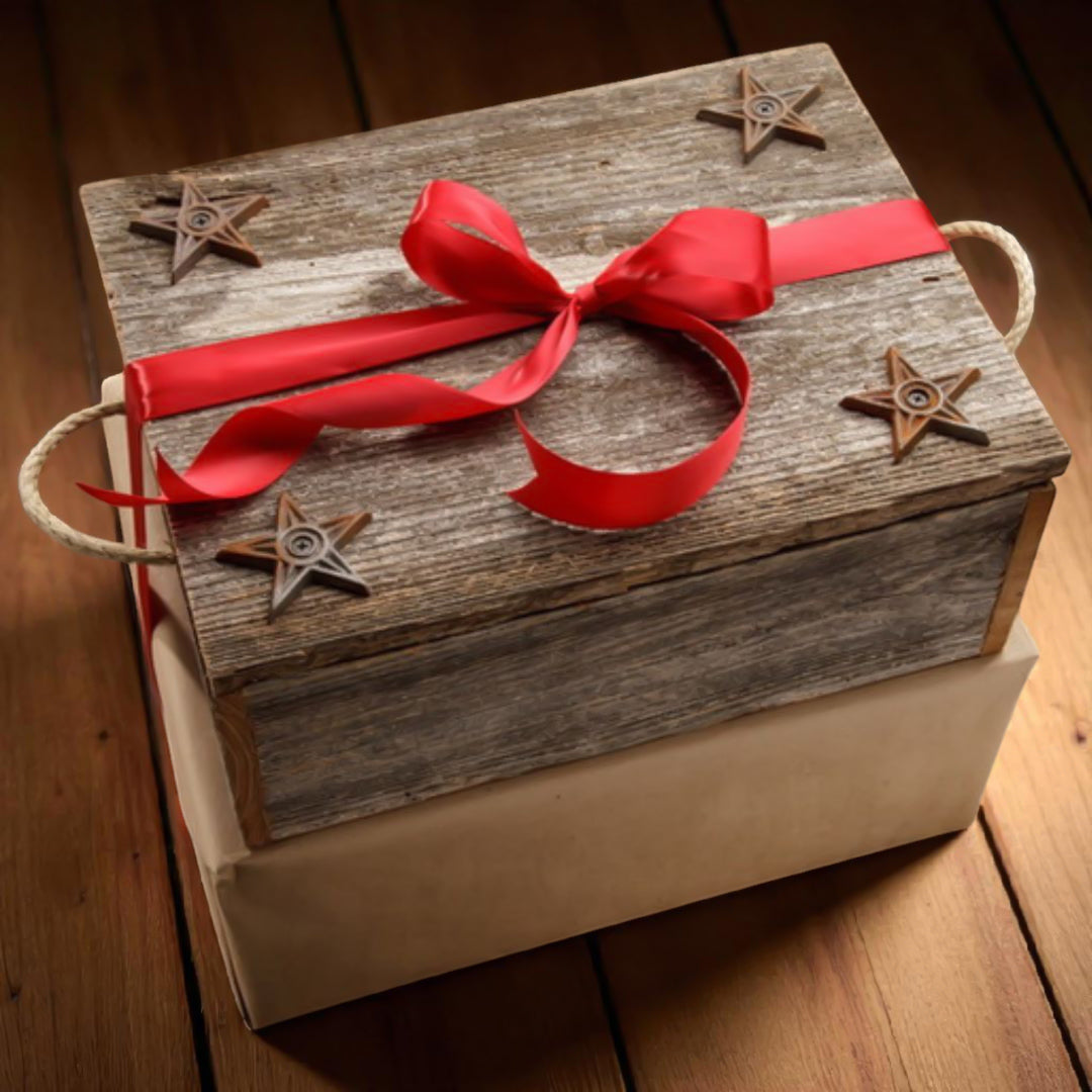 Wooden gift box with a red ribbon and star decorations on a wooden surface