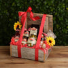 Gift basket with Ketchup & Mustard products, sunflowers, and a red ribbon on a wooden surface.