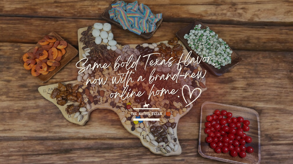 Wooden cutting board shaped like Texas with various food items on a wooden surface.